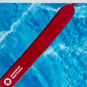 Lifeguard training course with rescue practice in a swimming pool.