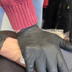 Adult CPR AED and First Aid training demonstration using Direct pressure for controlling a bleed.