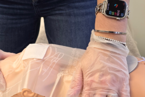 Diverse students practicing adult and pediatric CPR on training manikins during American Red Cross CPR class in Fairfax.