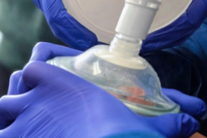 Close-up of a Basic Life Support (BLS) provider performing CPR during American Red Cross training.